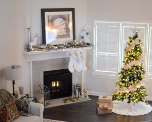 green and white pre lit pine tree near fireplace inside well lit room