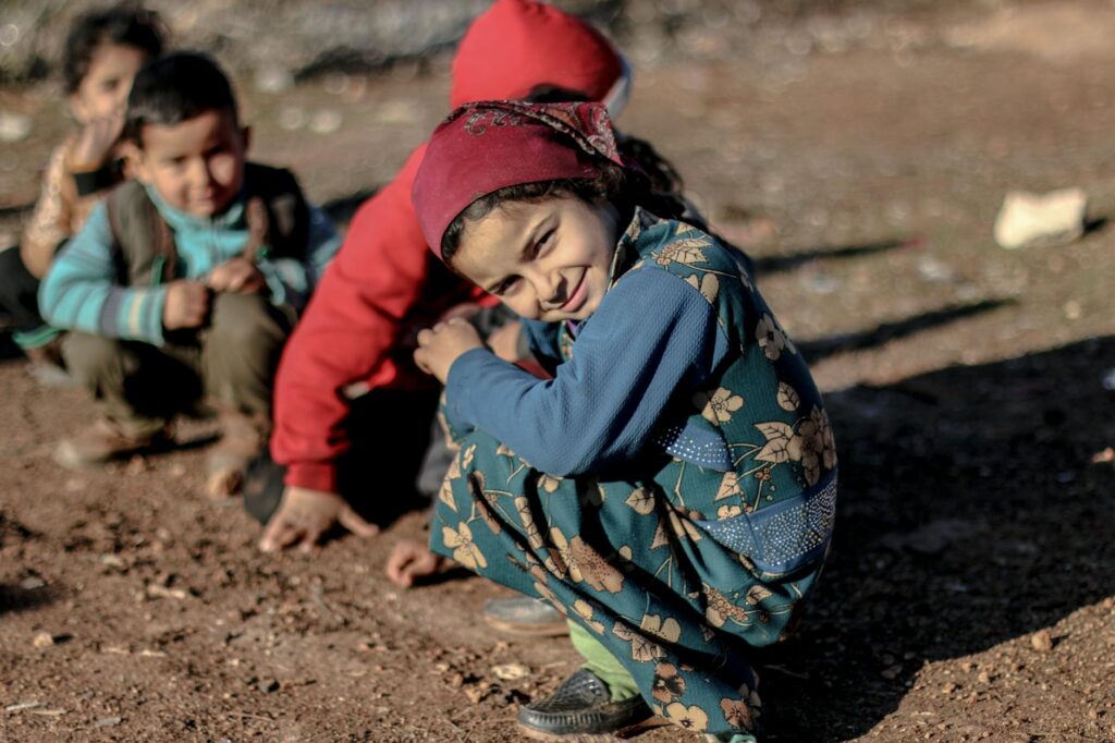 children playing outside in the mud