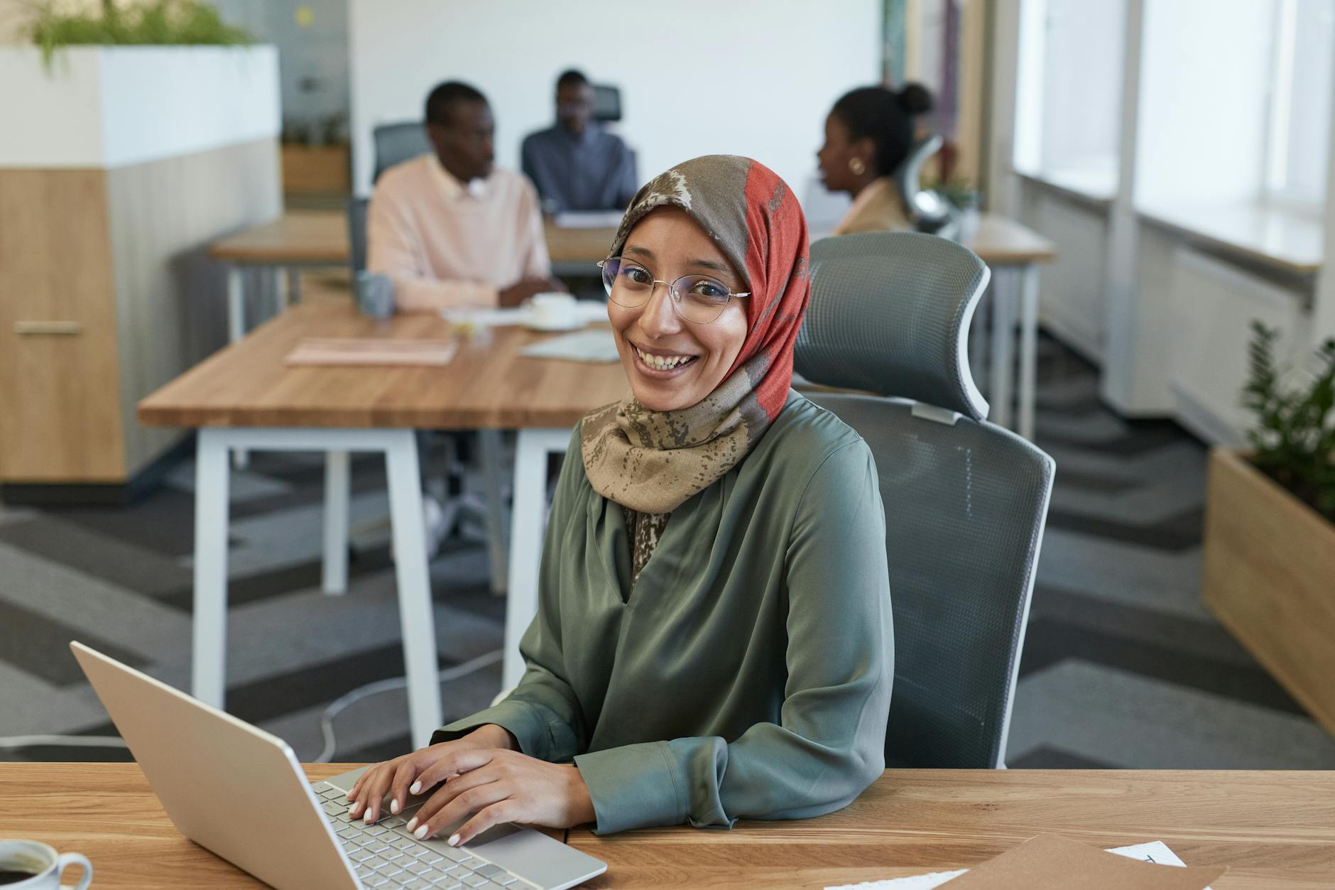 a smiling woman sitting on an office chair