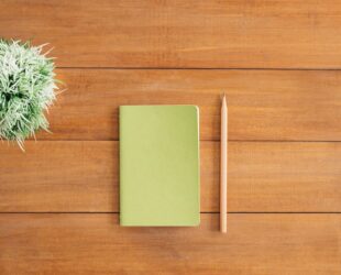white notes beside a pencil on brown wooden surface