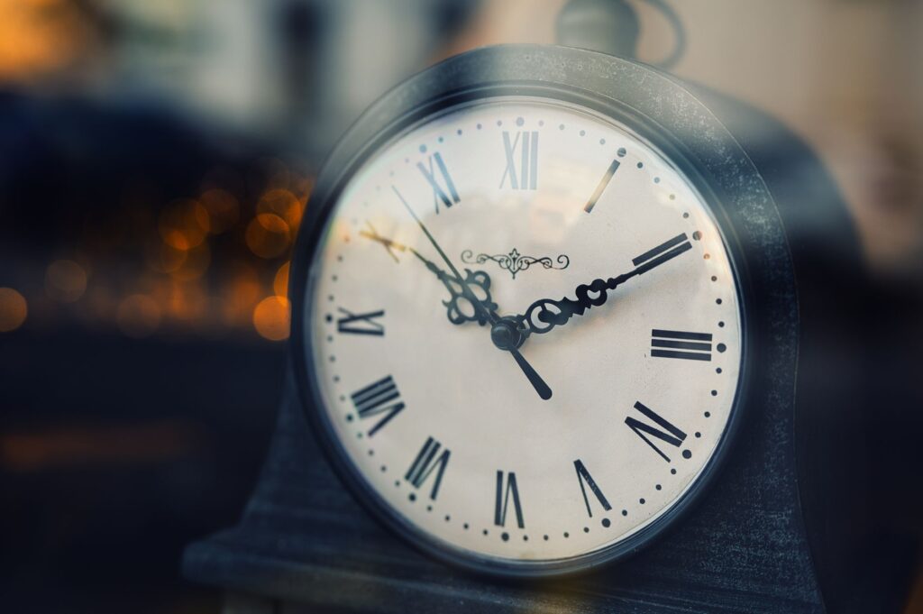 vintage clock with roman numerals at twilight