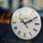 vintage clock with roman numerals at twilight