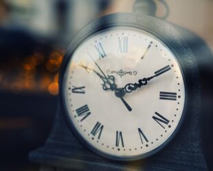 vintage clock with roman numerals at twilight